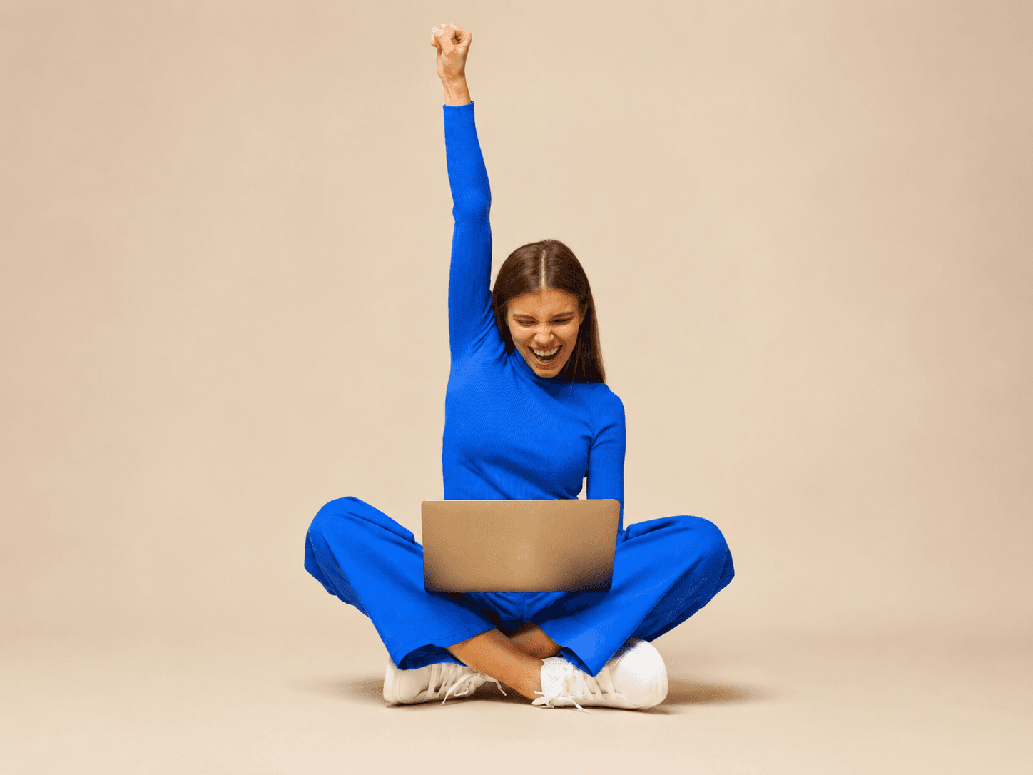 A woman celebrating her blood-test results on her laptop